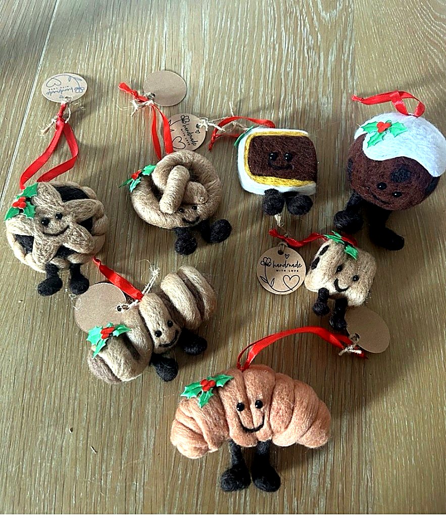 Set of festive pastry ornaments with holly and red ribbons