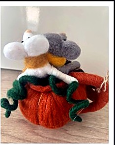 Two felt mice in an orange pumpkin