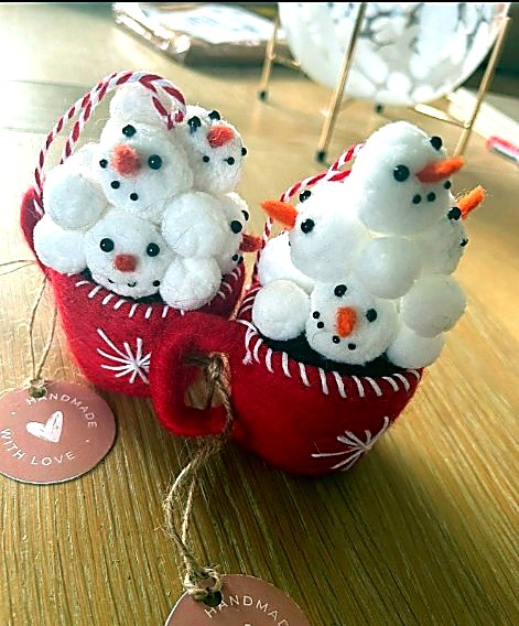 Pair of red felt cocoa-mug ornaments filled with tiny snowmen